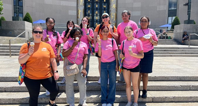  A group of 2024 Youth Ambassadors stand together with ice cream on a field trip.